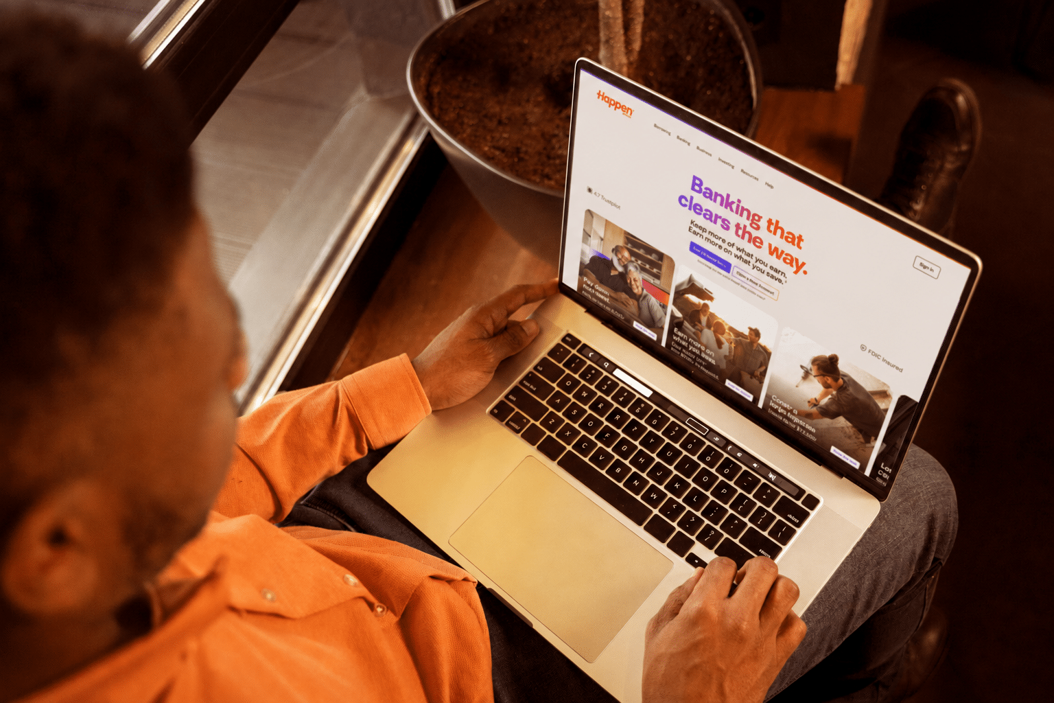 Happen Bank website shown on a laptop